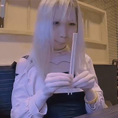 Woman With Long Blonde Hair Holding Chopsticks GIF
