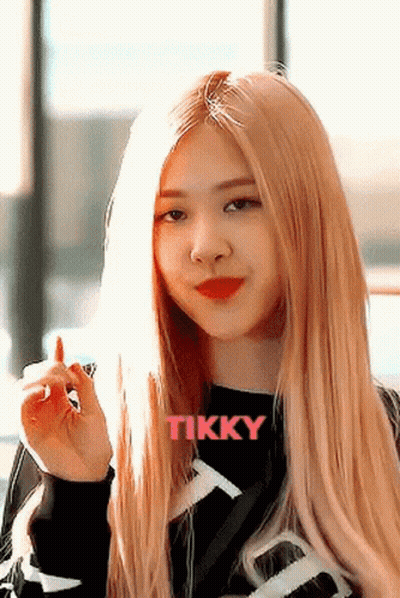 Woman With Long Blonde Hair In Black Tikky Shirt GIF