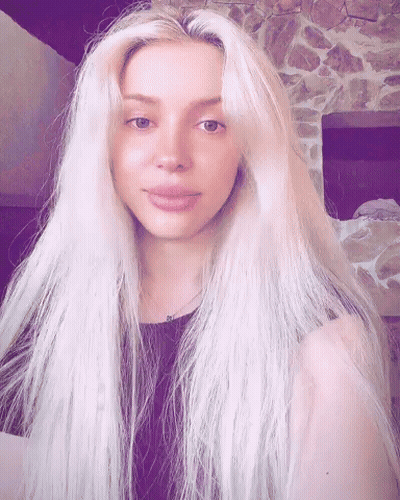 Woman With Long Blonde Hair In Black Top GIF