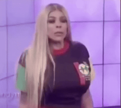 Woman With Long Blonde Hair In Colorful Shirt GIF