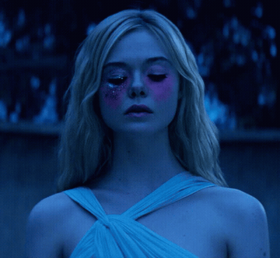 Woman With Long Blonde Hair Looking At Camera GIF