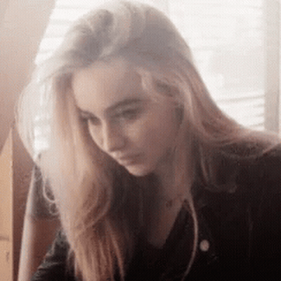 Woman With Long Blonde Hair Looking Down GIF