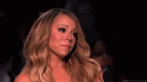 Woman With Long Blonde Hair Sitting In Dark Room Eyes Closed GIF