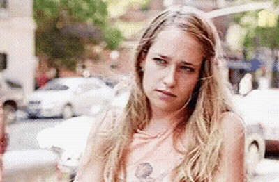 Woman With Long Blonde Hair Standing Crossed Arms GIF