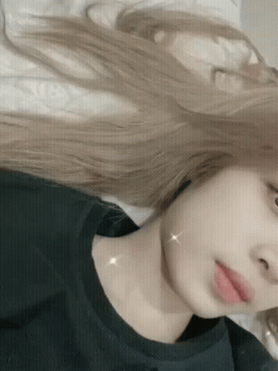 Woman With Long Blonde Hair Taking Selfie In Bed GIF