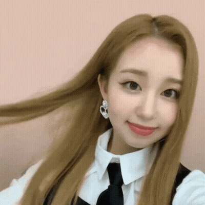 Woman With Long Blonde Hair Wearing Earrings And Tie GIF