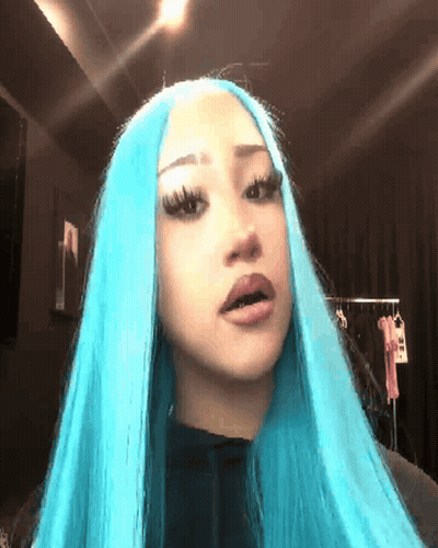 Woman With Long Blue Hair Looking At Camera GIF