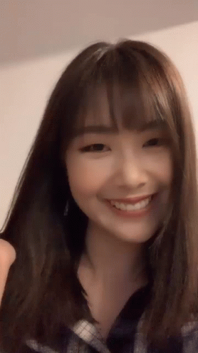 Woman With Long Brown Hair And Bangs Smiling GIF