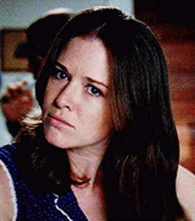 Woman With Long Brown Hair In Blue Polka Dot Top GIF
