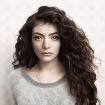Woman With Long Curly Hair And Gray Sweater GIF