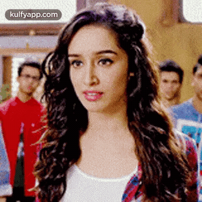 Woman With Long Curly Hair Facing Men GIF