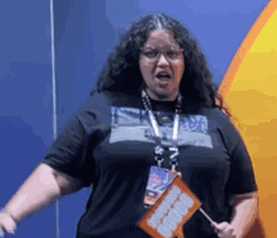 Woman With Long Curly Hair Holding I Love You Sign GIF