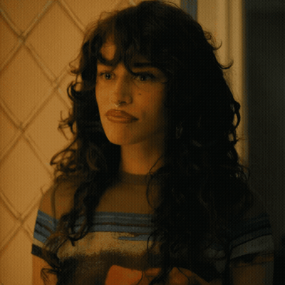 Woman With Long Curly Hair In Striped Shirt GIF