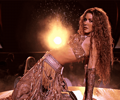 Woman With Long Curly Hair Kneeling GIF