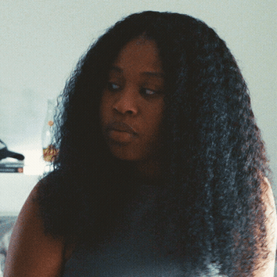 Woman With Long Curly Hair Looking To The Side GIF