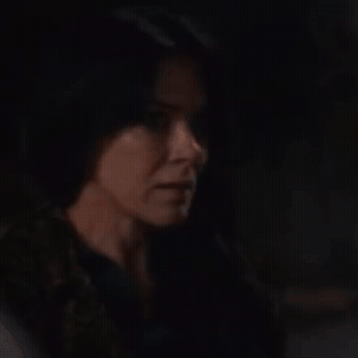 Woman With Long Dark Hair Holding Her Head GIF