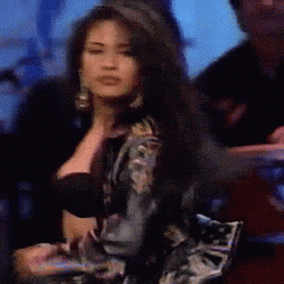 Woman With Long Dark Hair In Black Bra And Floral Jacket GIF