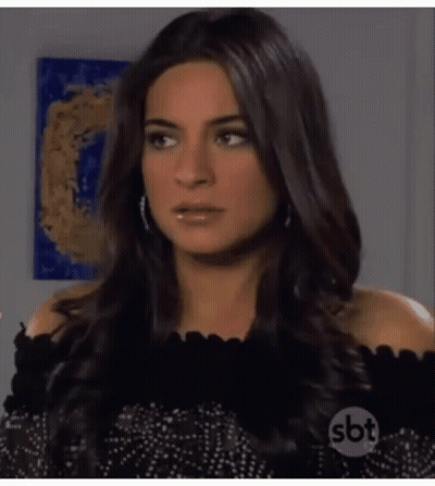 Woman With Long Dark Hair In Black Off Shoulder Top GIF