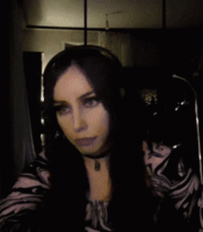 Woman With Long Dark Hair In Choker And Zebra Print Shirt GIF
