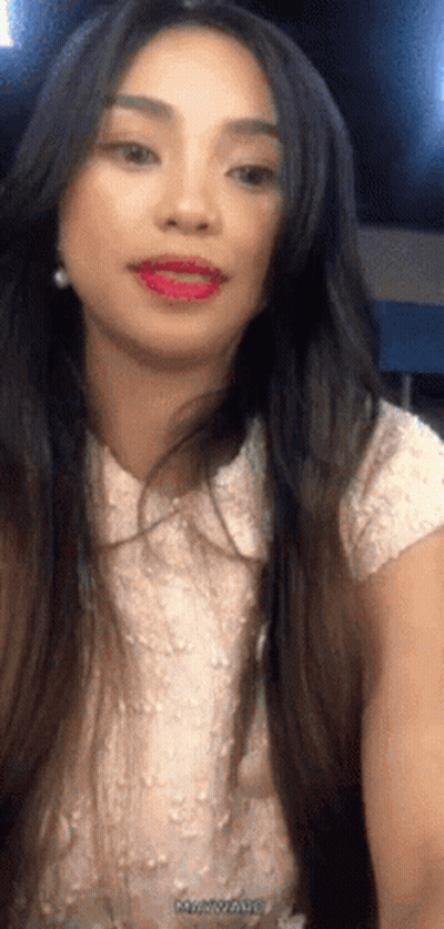 Woman With Long Dark Hair In White Top And Earrings GIF