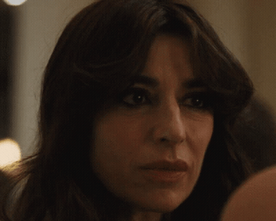 Woman With Long Dark Hair Looking At Camera GIF