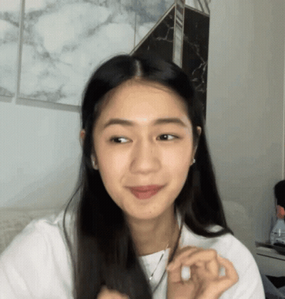 Woman With Long Dark Hair Looking At Camera GIF