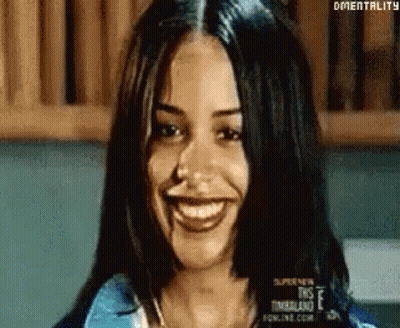 Woman With Long Dark Hair Smiling At Camera GIF