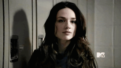 Woman With Long Dark Hair Standing In Front Of Locker GIF