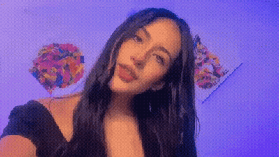 Woman With Long Dark Hair Taking Selfie At Painting GIF