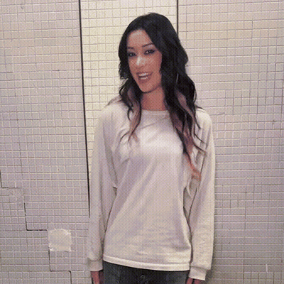 Woman With Long Dark Hair Wearing White Shirt And Scarf GIF