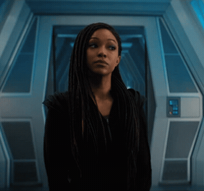 Woman With Long Dreadlocks In Dark Room GIF