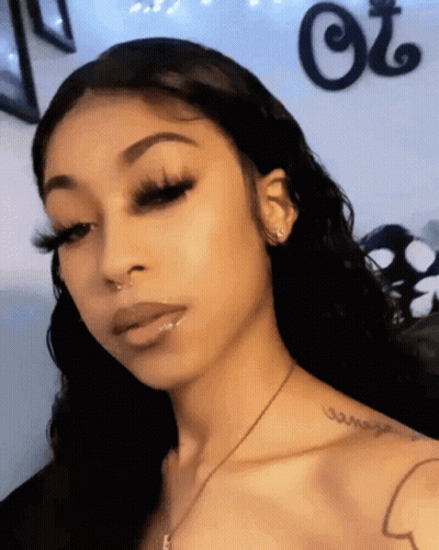 Woman With Long Eyelashes And Shoulder Tattoo GIF