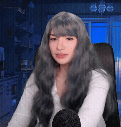 Woman With Long Grey Hair Sitting In Chair GIF