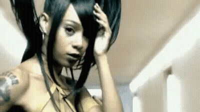 Woman With Long Hair And Arm Tattoo In Hallway GIF
