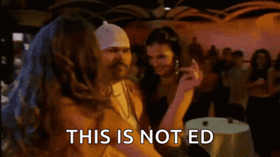 Woman With Long Hair And Arm Tattoo Standing In Hallway GIF