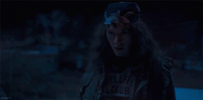 Woman With Long Hair And Bandana In Dark Room GIF
