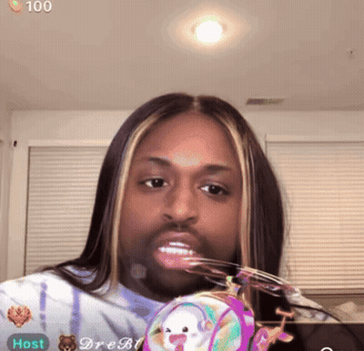 Woman With Long Hair And Beard Holding Purse Saying Host GIF
