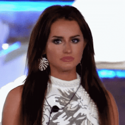 Woman With Long Hair And Earrings Making Funny Face GIF