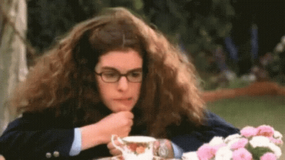 Woman With Long Hair And Glasses Drinking Tea GIF