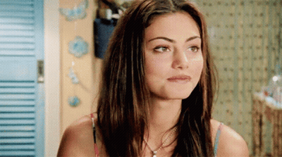 Woman With Long Hair And Necklace Looking At Camera GIF