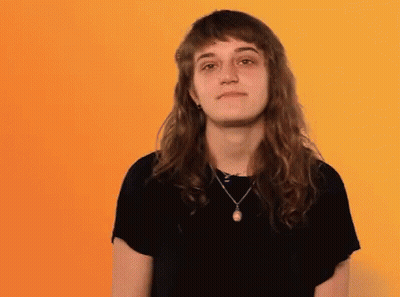 Woman With Long Hair And Necklace Making Funny Face GIF