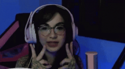 Woman With Long Hair And Necklace Making Funny Face GIF