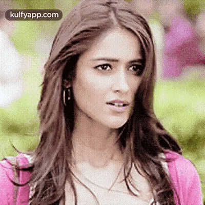 Woman With Long Hair And Pink Sweater Making Funny Face GIF
