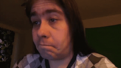 Woman With Long Hair And Purple Lipstick In Leather Pants GIF