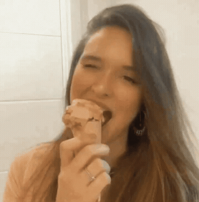Woman With Long Hair Eating Bread GIF