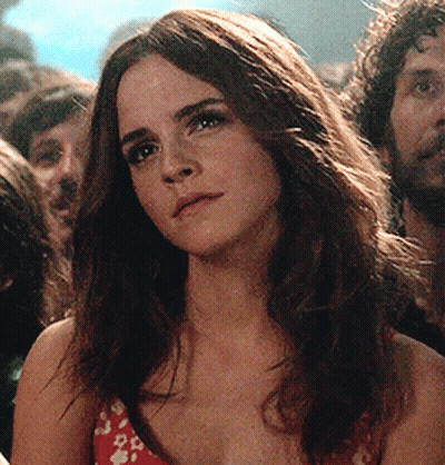 Woman With Long Hair In Crowd Looking At Camera GIF