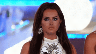 Woman With Long Hair In Earrings And White Top GIF