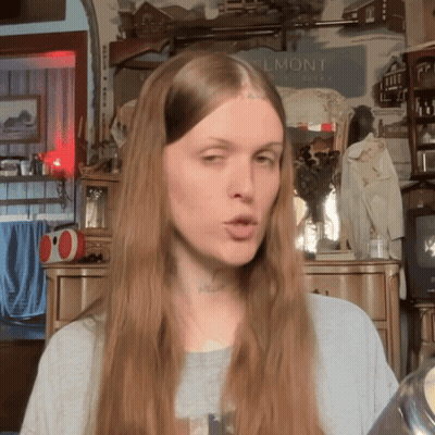 Woman With Long Hair In Front Of Belmont Sign GIF