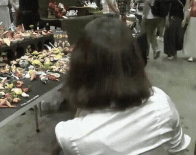 Woman With Long Hair in Pink Shirt and Necklace Saying Robertooooo