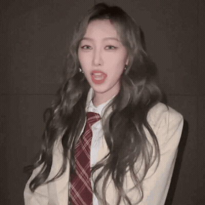 Woman With Long Hair In Plaid Tie And White Jacket GIF